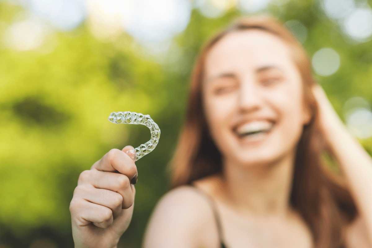 woman holding dental retainers Creekside Dental