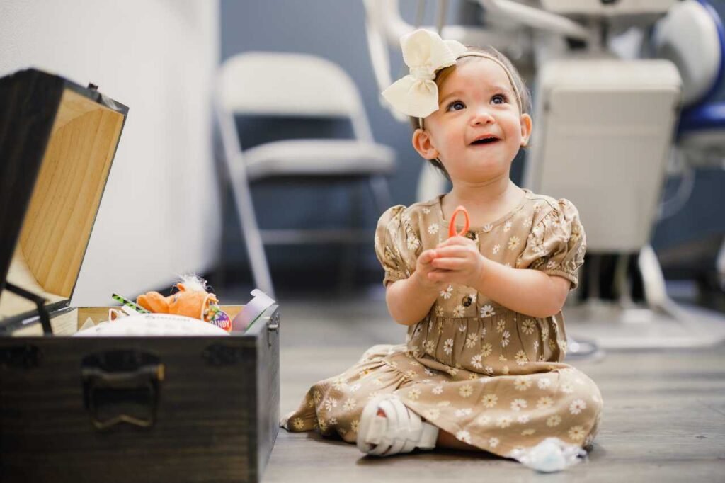 baby sitting down and looking at camera Creekside Dental