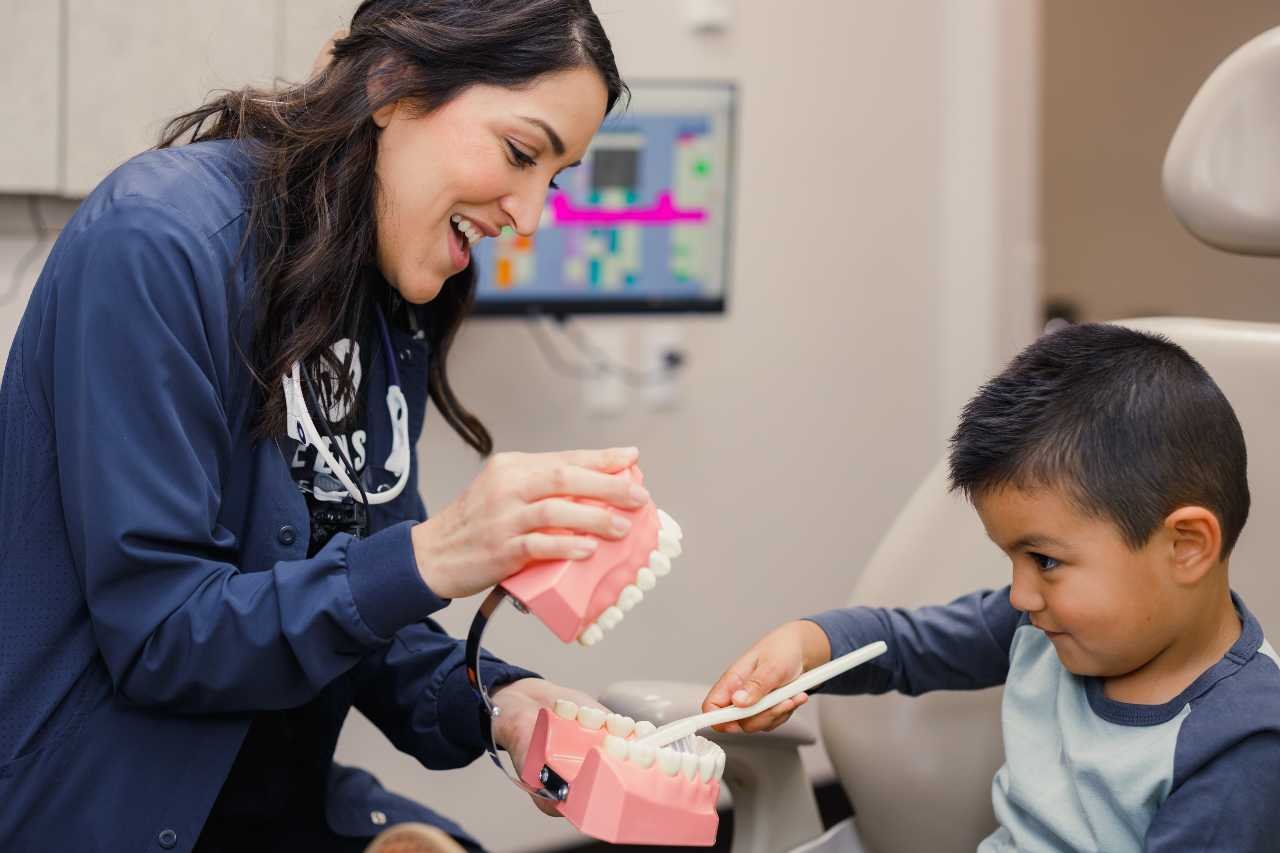kid brushing teeth with dentist Creekside Dental