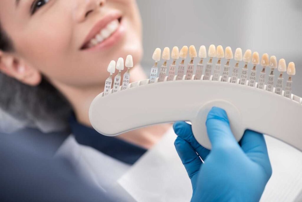 dentist showing patient crown replacement options Creekside Dental