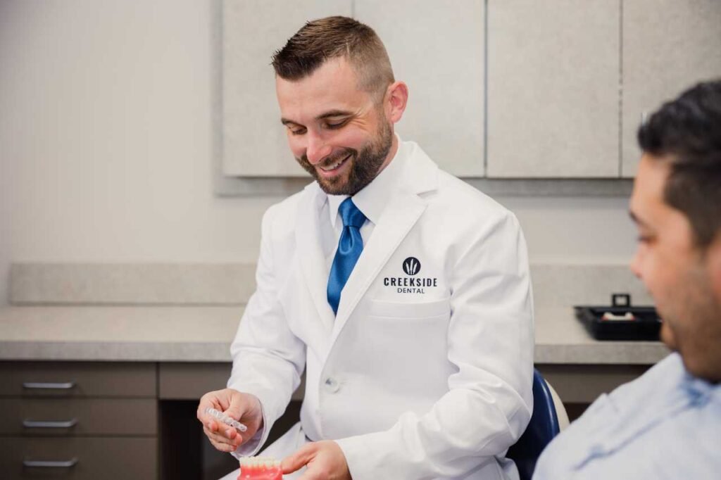 Dr. Bennett of Creekside Dental showing the patient how invisalign works