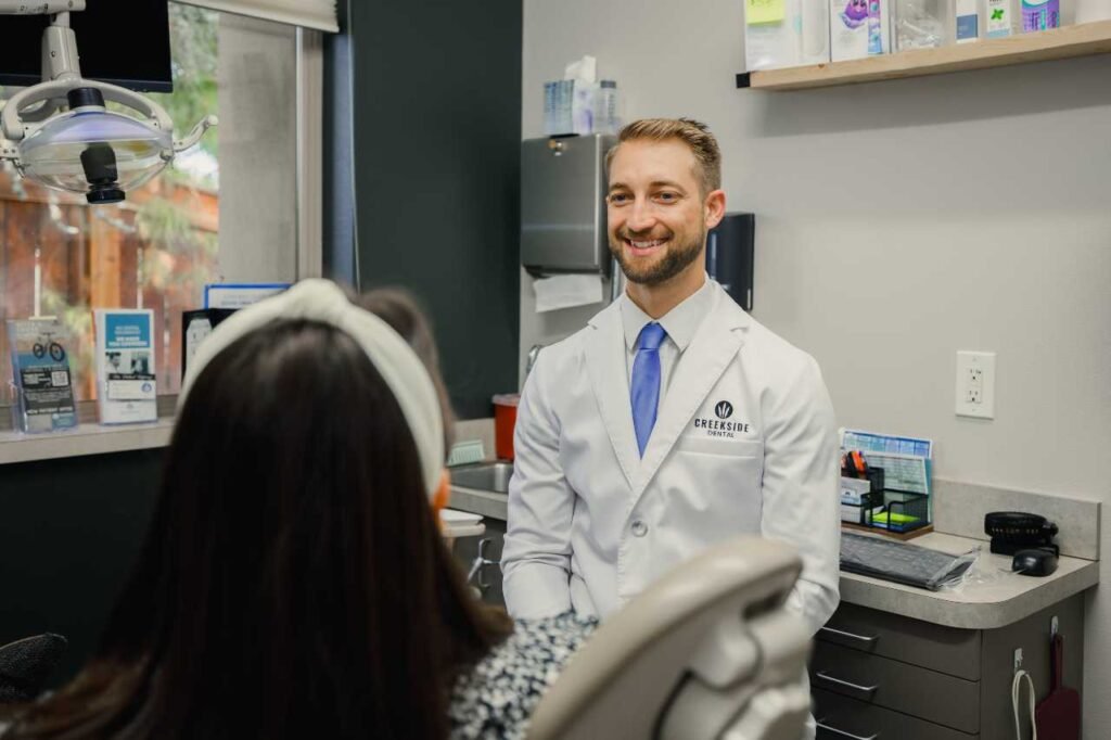 Dr Jordan doing a follow up check up Creekside Dental