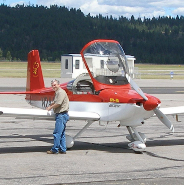 Dr. Packard beside a plane