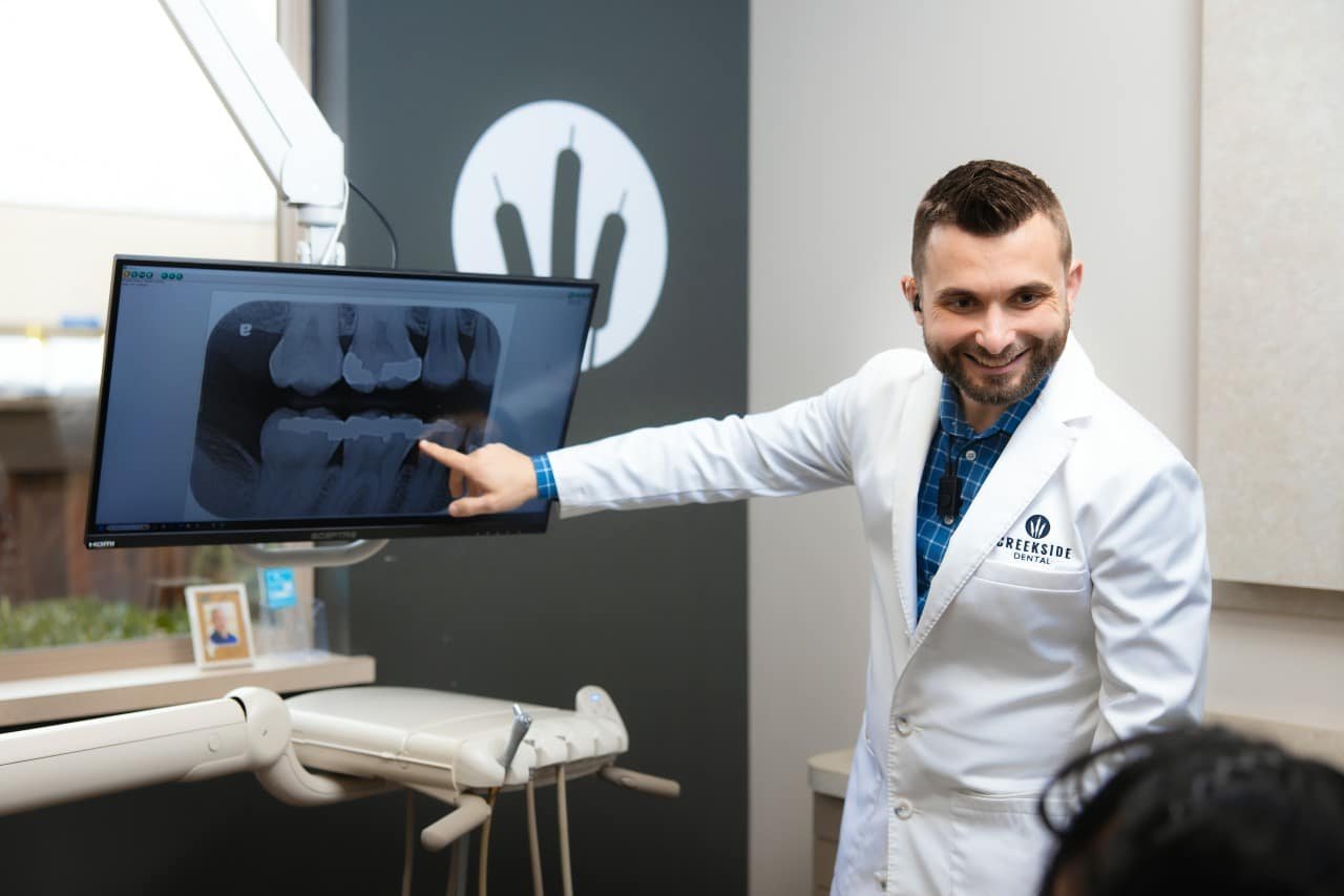 Dr. Bennett pointing to the dental screen