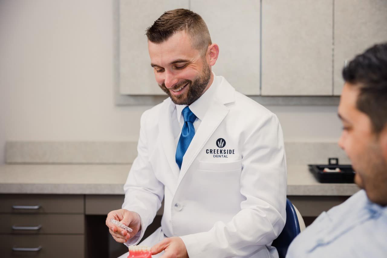 Dr. Bennett holding an Invisalign