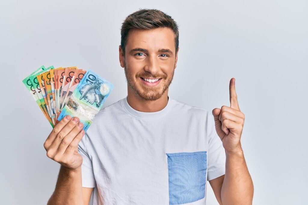 man holding australian dollars